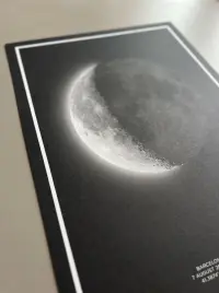 Close-up of a moon phase print of a crescent moon on a table