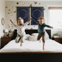 Kids jumping from a bed with starrymaps prints behind them
